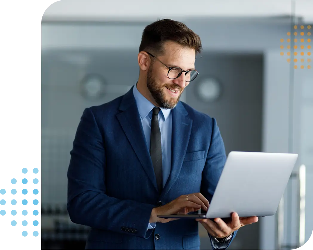 businessman looking at his laptop & smiling