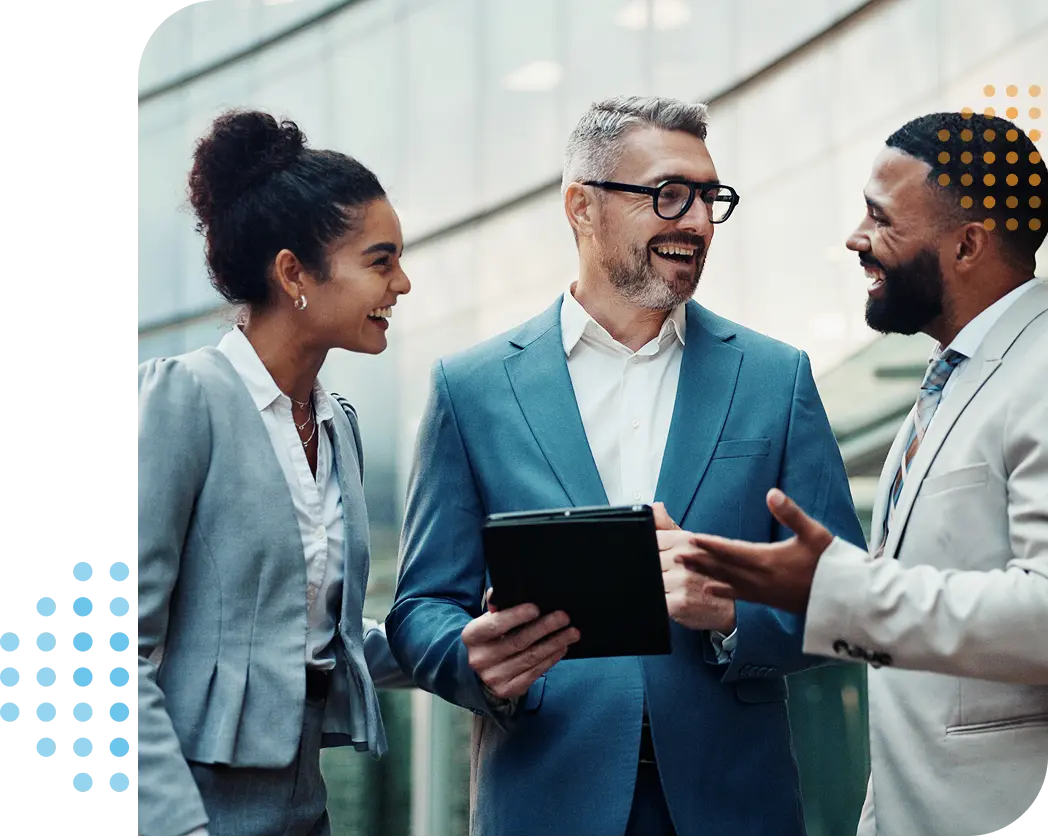 businessmen & businesswoman smiling & talking outside with the guy in the middle holding a tablet