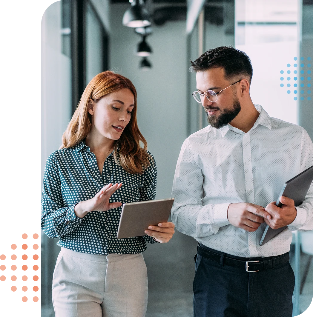 man & woman in a hallway with tablets - soluta billing features