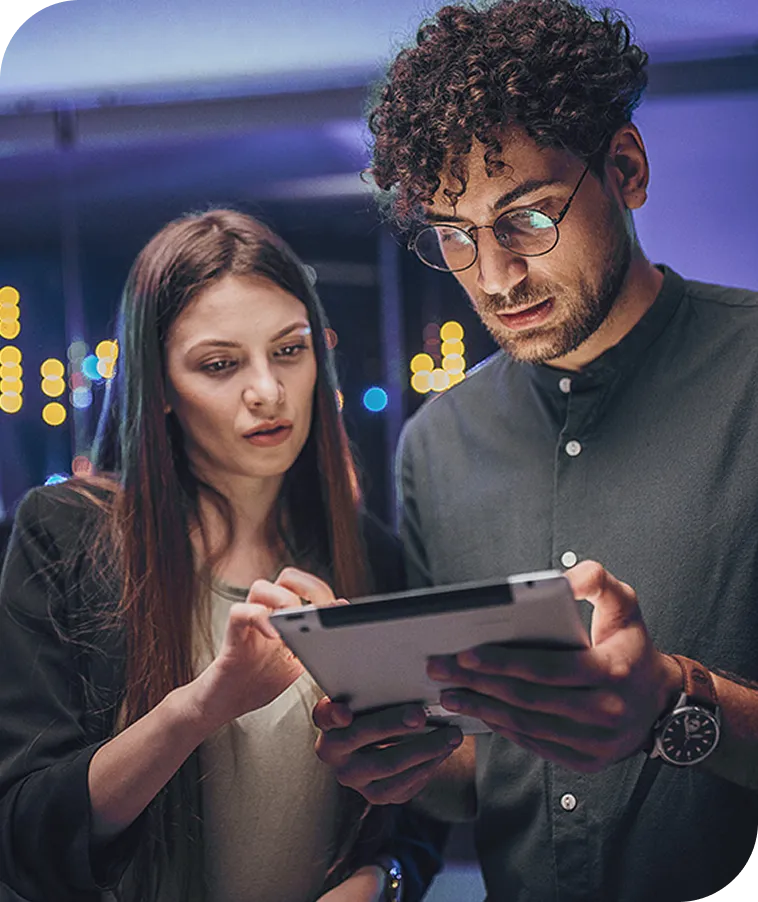 man & woman looking at a tablet in a server room